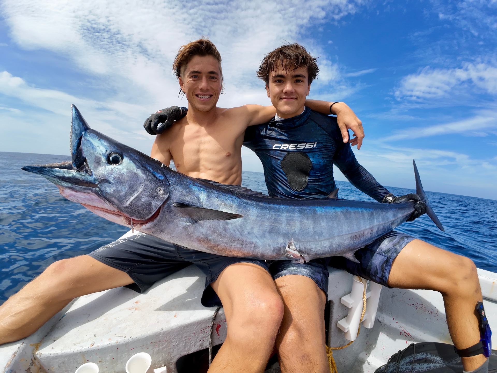 Christopher and Daniel on the boat with a wahoo
